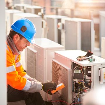 A technician performing an inspection as part of HVAC Services in Bloomington IL