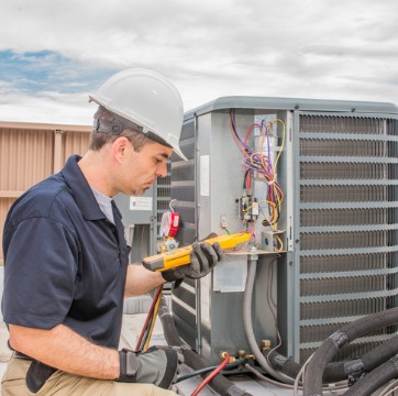 A technician performing repair during Air Conditioner Service in Normal IL