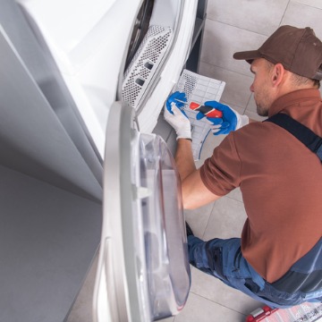 An employee of Chambers Services performs dryer repair in Bloomington IL