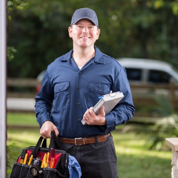 An employee of Chambers Services is at the door of a house to provide washer repair in Bloomington IL