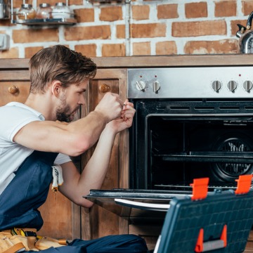 A team member of Chambers Services provides an oven repair in addition to being an Air Conditioning Contractor in Bloomington IL