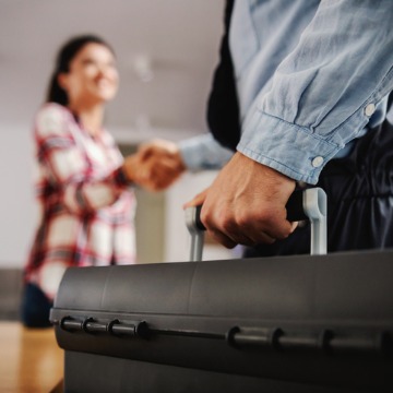 A woman shakes the hand of her repairman after calling for AC Inspections in Normal IL