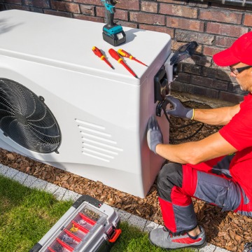 A technician services a unit after a homeowner called for AC Inspections in Peoria IL