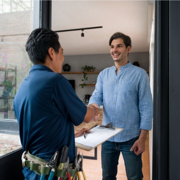 A homeowner shakes the hand of a team member from Chambers Services, who provides AC Service Near You