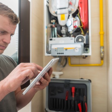A man performing Heating Service in Champaign IL for a broken furnace