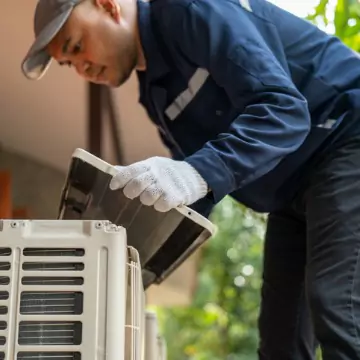 A member of Chambers Services services an air conditioner after a homeowner called that their AC is Running But Not Cooling