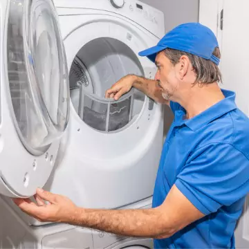 A Chambers technician checking the lint trap during dryer repair in Bloomington IL