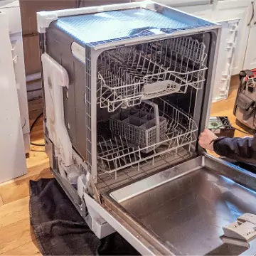 A Chambers technician pulling out a dishwasher unit to provide effective Dishwasher Repair in Central Illinois