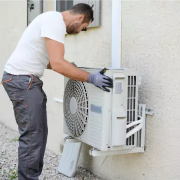 A Chambers technician placing an outdoor air conditioning unit during AC Installation in Central Illinois