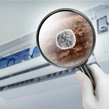 A magnifying glass checking germs and allergens that need to be filtered through air purifiers