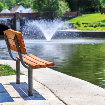 A park bench overlooking a pond located at Miller Park in Bloomington, Illinois