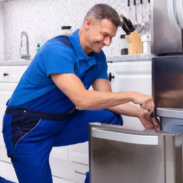 A Chambers Tech looking at the freezer box of a fridge, attempting refrigerator repair in Decatur IL