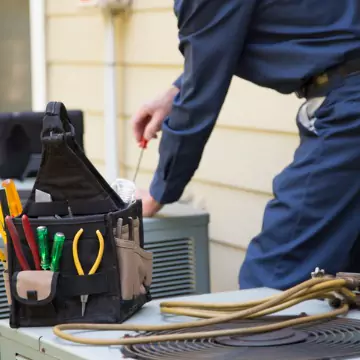 A Chambers Technician who specializes in HVAC and appliance service in Peoria helping fix an AC unit