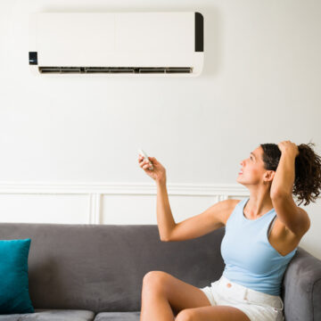 Air Conditioning Contractor Bloomington IL, Hot young woman feeling sweaty during a heat wave because her air conditioning is not working