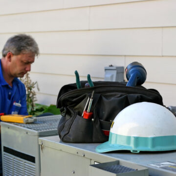 AC Maintenance Bloomington IL, Man working on AC unit